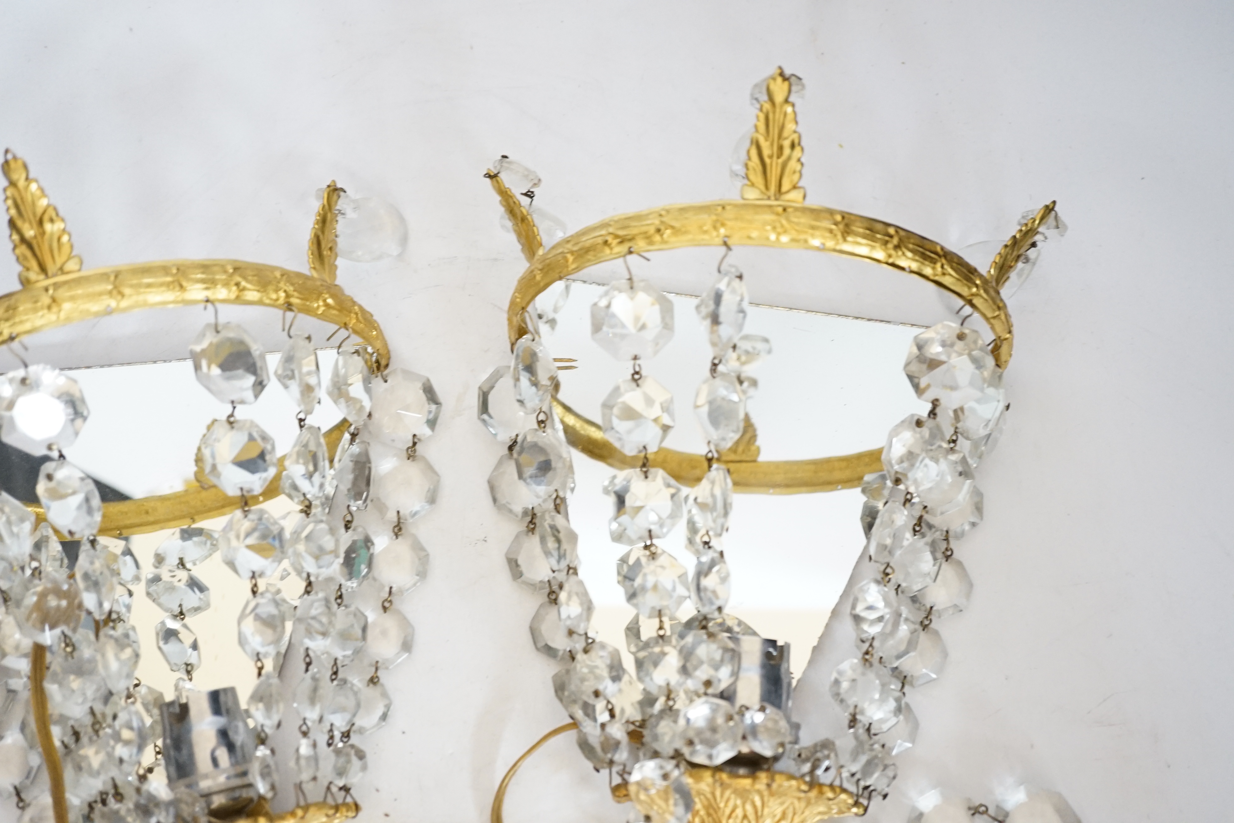 A pair of gilt mounted lustre wall lights, 23cm high
